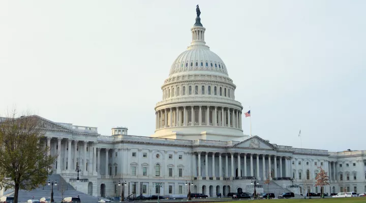 Stock photo showing the exterior and domed roof of the United States capitol building.