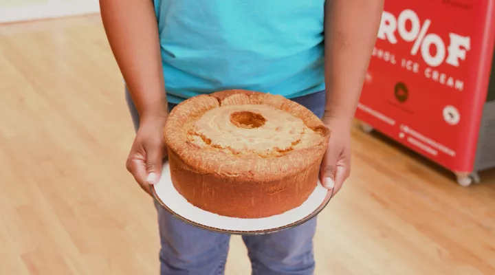 Photo of someone holding a cake.