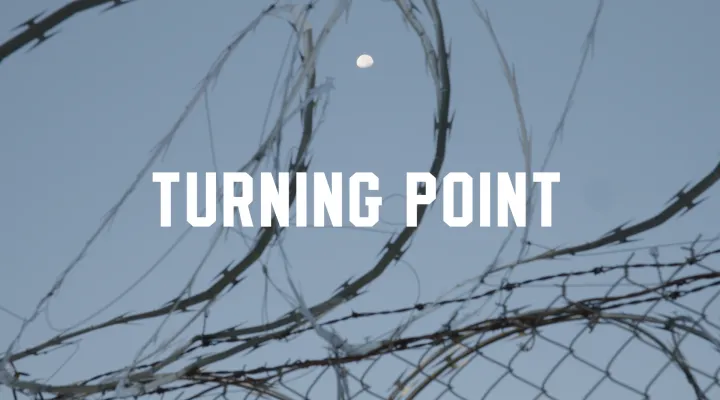title turning point displayed with barbed wire fence in background