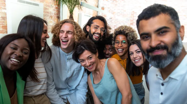 photo of a mixed group of people standing together smiling