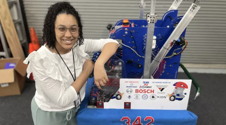 photo of Victoria Zamora standing next to robot project