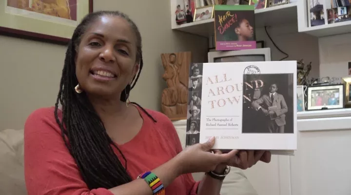 Dinah Johnson holding All Around Town book