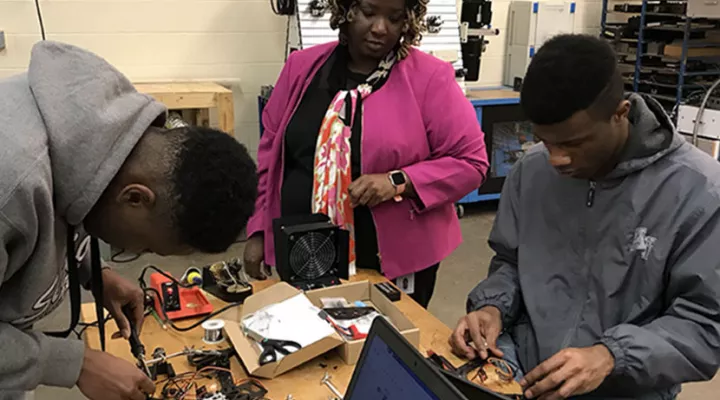 Teacher with students in class - photo from February 2019 Carolina Classrooms