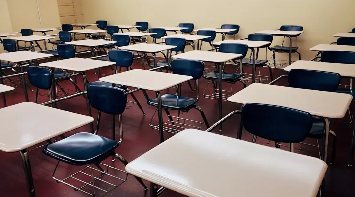 Empty desks in an empty classroom