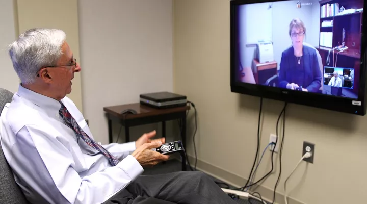 Ed Spencer demonstrates the Telepsychiatry program's high definition technology for video conferencing.