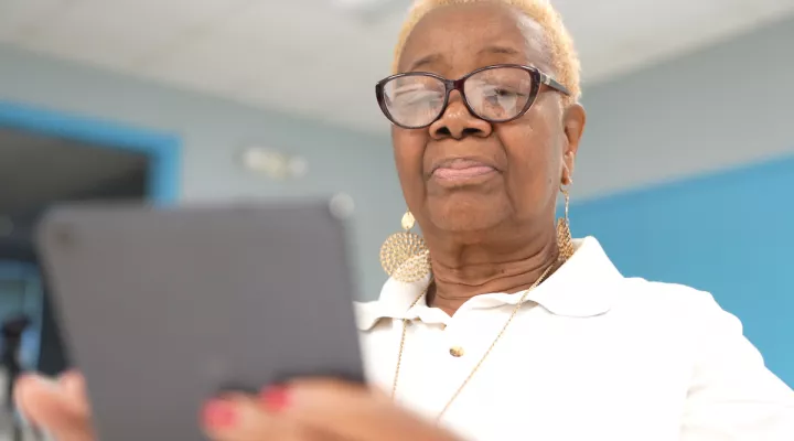 Senior participant using their tablet for the Digital Literacy Program 