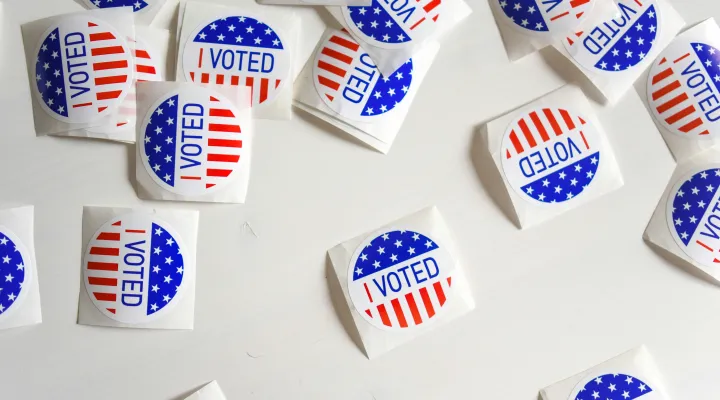 photo of several "I voted" stickers on a white tabletop