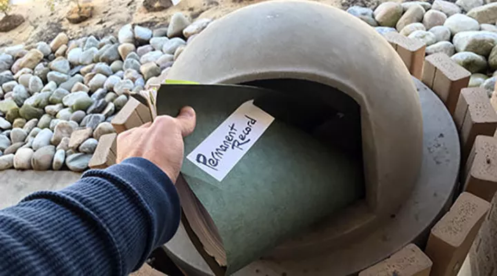 man placing file in trash