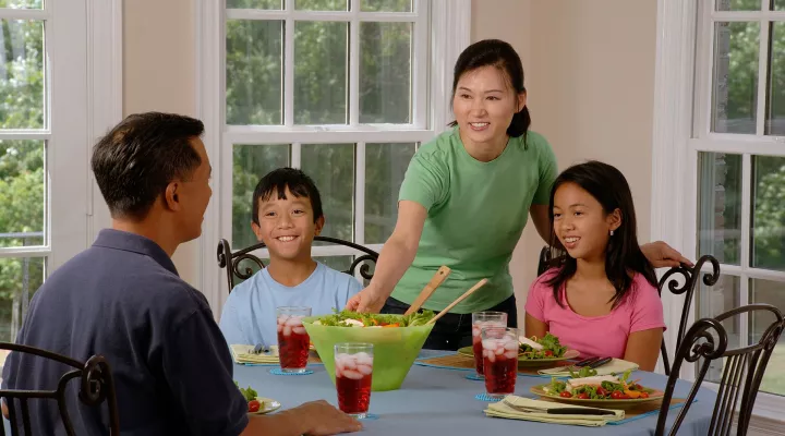 A family shares a meal at the table. 
