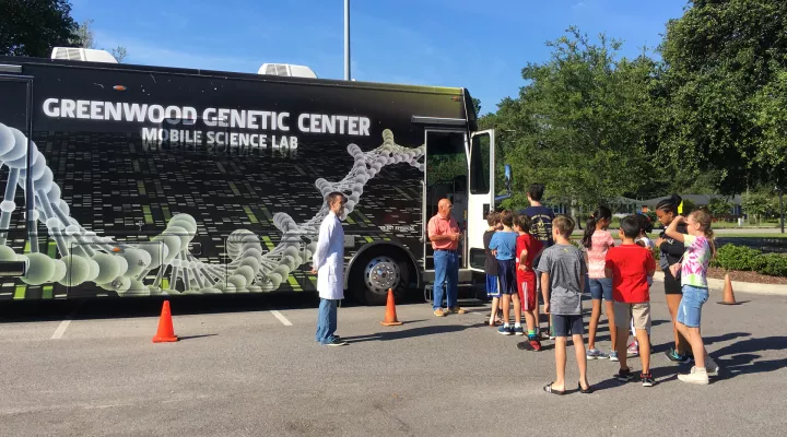 Students line up outside of the Greenwood Genetics Center Mobile Science Lab 