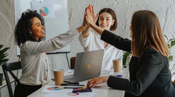 picture of 3 women 'high-fiving' each other