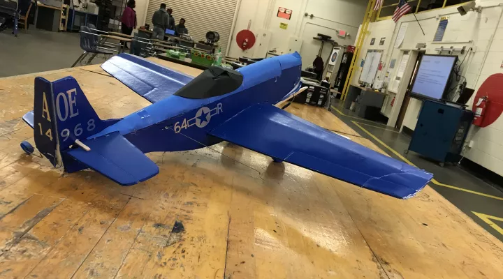 A large model airplane sits on a table at the Sumter Career and Technology Center