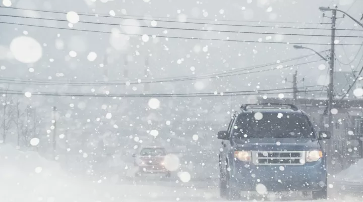 cars driving in winter storm