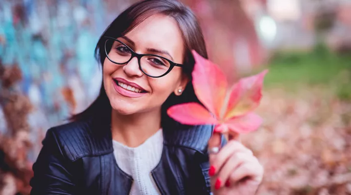 photo of woman holding a leaf