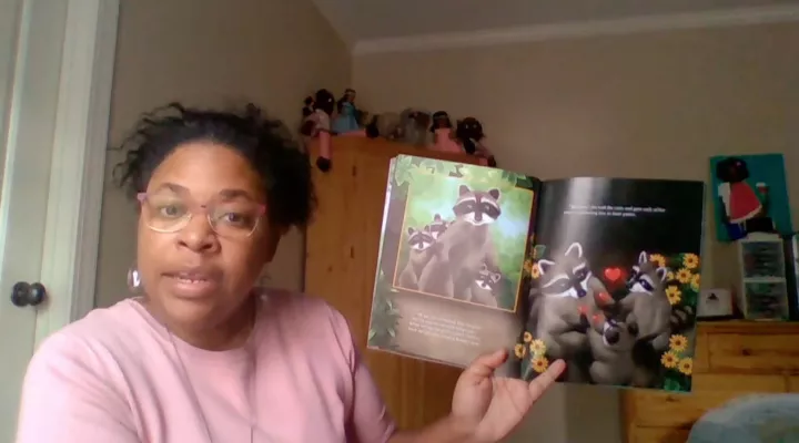Jennifer Pinckney holding the children's book, Chester Raccoon and the Big Bad Bully