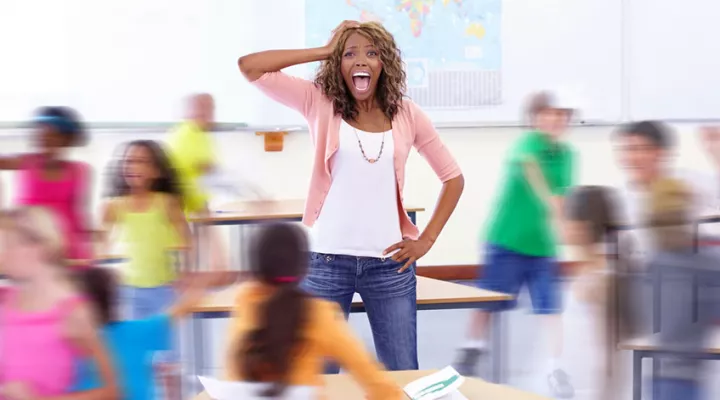 image of teacher in middle of busy classroom