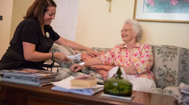 Nurse Mary Guillaume assesses Eleanor Grayson at her cottage at the Village at Summerville nursing home.