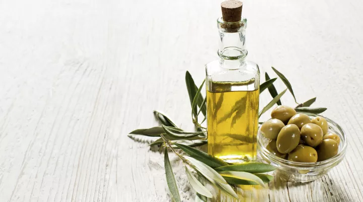 bottle of olive oil with olives