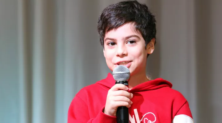 picture of student holding a microphone