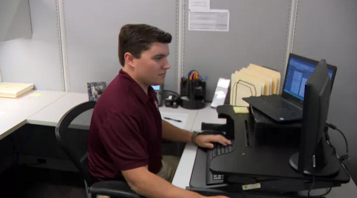 Thomas Jones sitting at desk in office