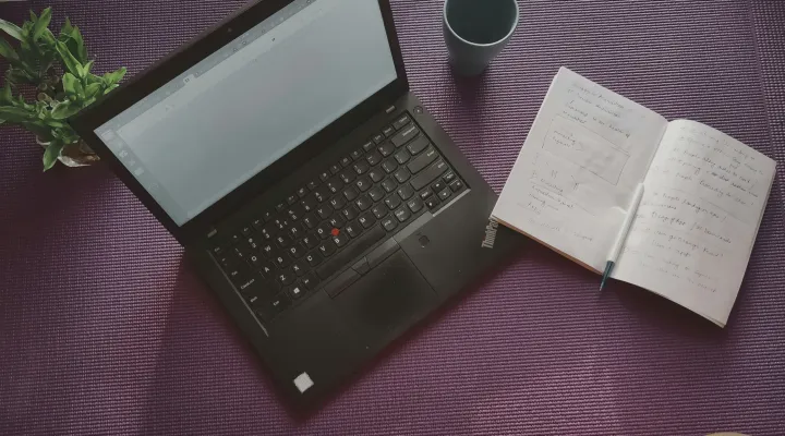 photo of an open laptop and notepad