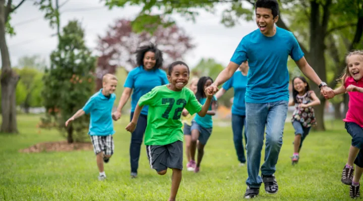 photo of parents and children running