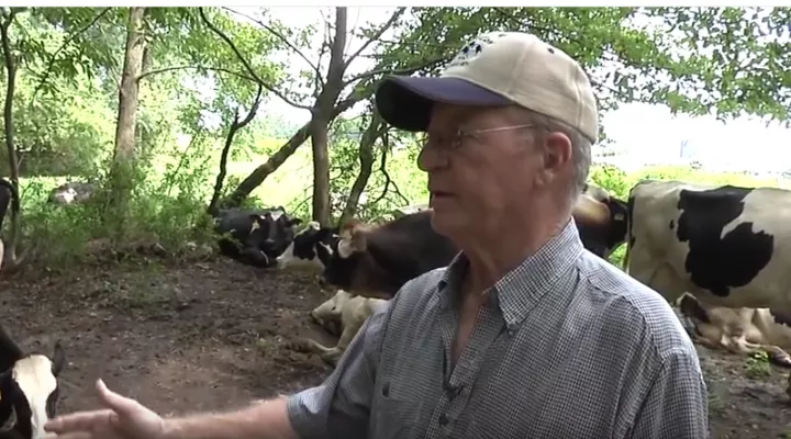 farmer with his cows at Happy Cow Creamery