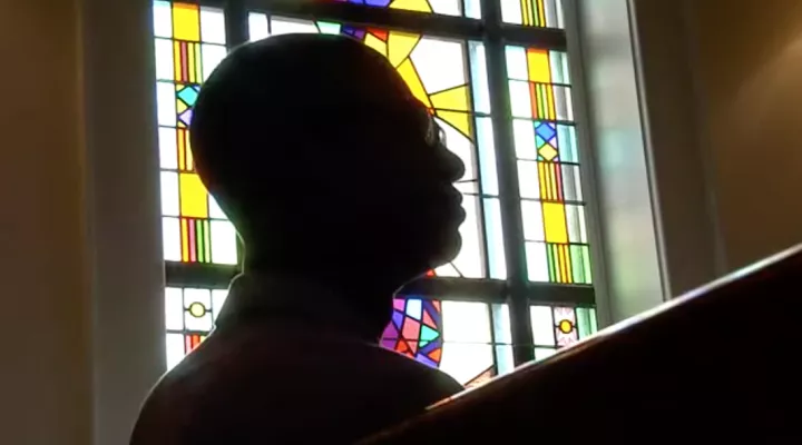 Gordon sitting in front of a church window.