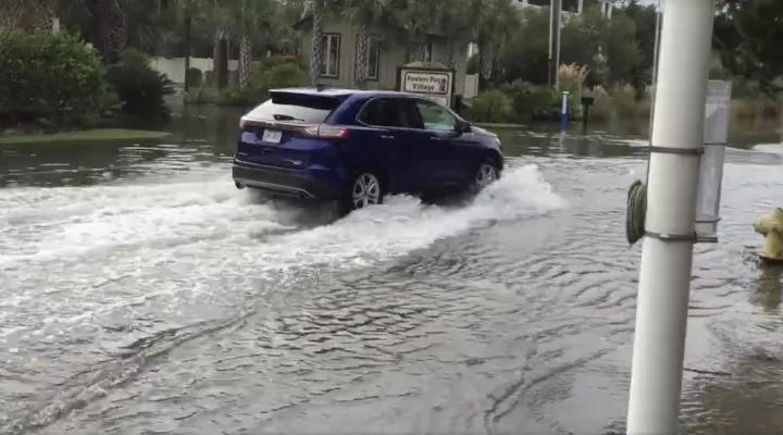 Car driving through flooded water