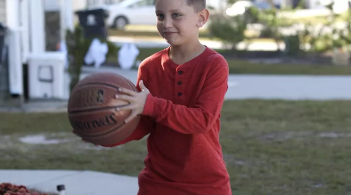 Jayden playing basketball