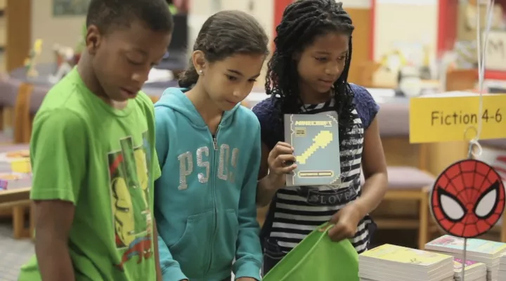 Students receiving books