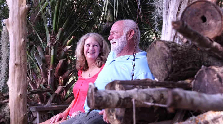 Chapmans sit on a homemade swing taking in their view on Wadmalaw Island.