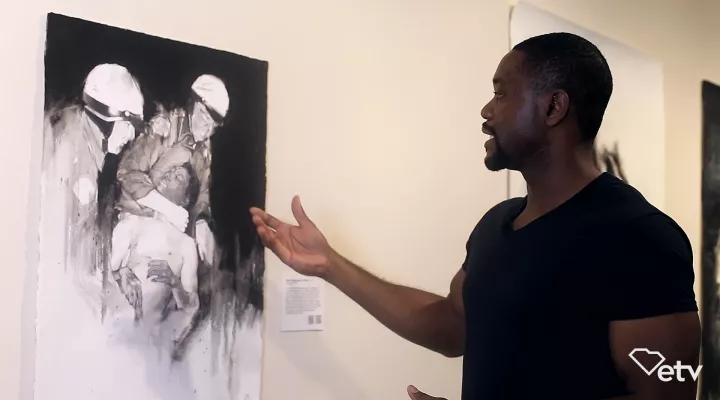 Artist Charles Williams explaining his artwork.