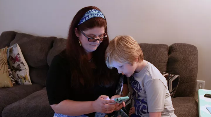 Cooper and his mom Sarah use the TeleBurn App.