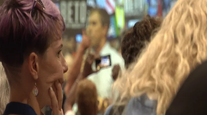 A woman watches former Congressman Beto O"Rourke speak at the South Carolina Democratic Party Convention on June 22, 2019