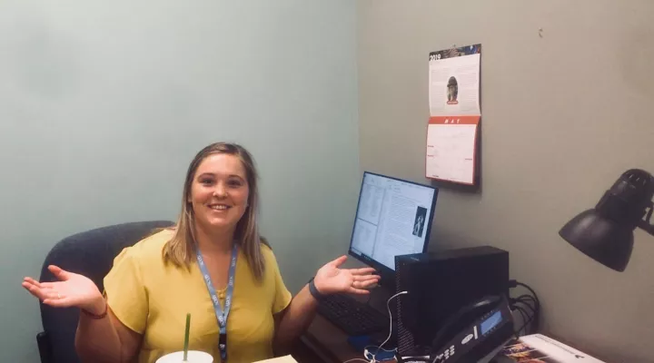 Sarah shows off her desk. 