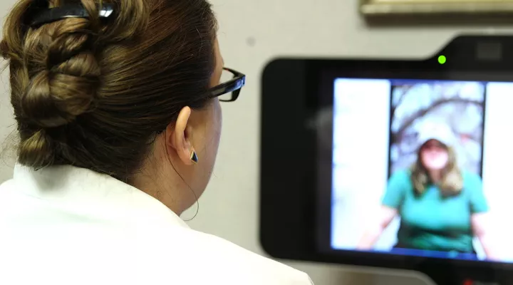 A doctor and patient use tele-psychiatry for an appointment.