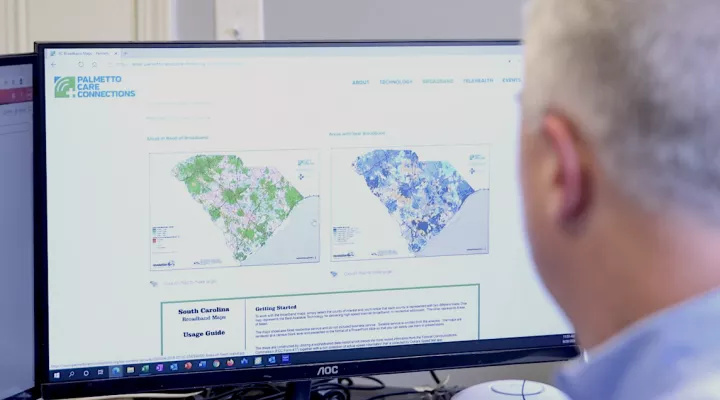 Matt Hiatt with PCC looking at Broadband maps.