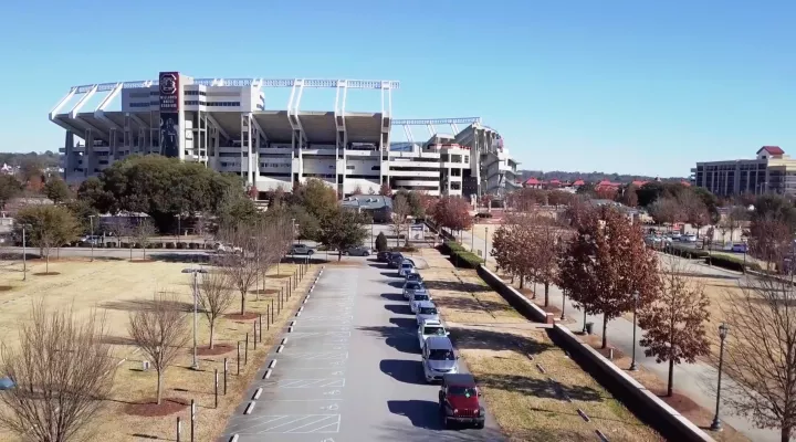 Cars line up outside of the Gamecock Park Prisma Health vaccination site in February 2021.