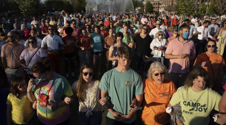 People participate in a memorial service and prayer vigil for the Lesslie family at Fountain Park, Sunday, April 11, 2021, in Rock Hill, S.C. Dr. Robert Lesslie and his wife, Barbara Lesslie, their grandchildren Adah Lesslie and Noah Lesslie, and two men working at the Lesslie home, Robert Shook and James Lewis, were fatally shot last week by former NFL player Phillip Adams. (AP Photo/Sean Rayford)