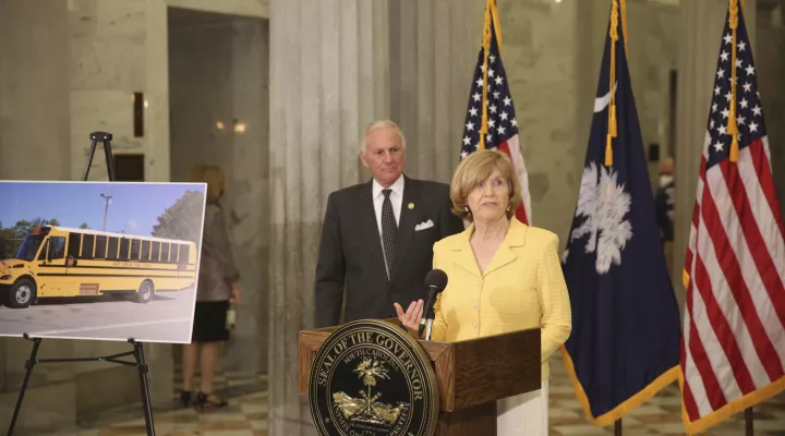 South Carolina Education Superintendent Molly Spearman, right, and Gov. Henry McMaster, left, announce the state will spend $24 million in a legal settlement on both school buses and regular buses that don't run on diesel fuel during a news conference on Tuesday, April 13, 2021, in Columbia, S.C. The money came from a settlement with Volkswagen over emission testing. (AP Photo/Jeffrey Collins).