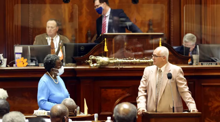 State Rep. Gilda Cobb-Hunter, D-Orangeburg, left, listens as Rep. Garry Smith, R-Simpsonville, right, talks about a bill that would require a semester course on America's founding for college students on Thursday, April 15, 2021, in Columbia, S.C. The bill passed 91-12. (AP Photo/Jeffrey Collins)