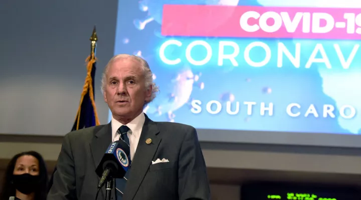 FILE - In this July 29, 2020 file photo, South Carolina Gov. Henry McMaster speaks during a COVID-19 briefing as state epidemiologist Linda Bell, left, looks on, in West Columbia, S.C. McMaster ended South Carolina’s ongoing pandemic-related state of emergency on Monday, June 7, 2021. The Republican said during a news conference that the coronavirus situation in the state had improved to the point that it was no longer necessary.  (AP Photo/Meg Kinnard, File)