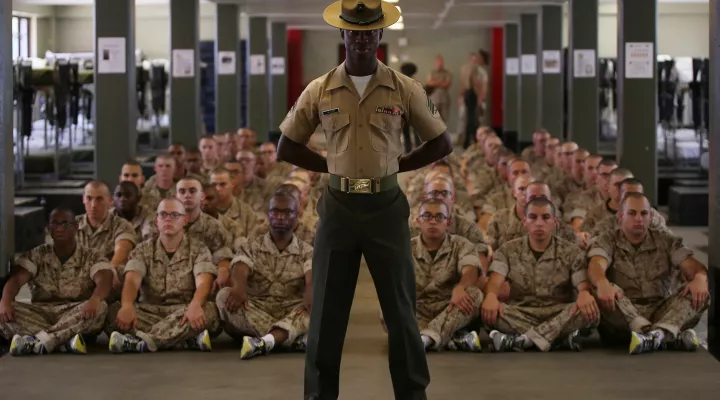 FILE - Drill instructor Sgt. Abraham Miller waits with Platoon 1056, Delta Company, 1st Recruit Training Battalion, moments before the recruits meet their new drill instructors June 7, 2014, on Parris Island, S.C. Miller, from Trenton, N.J., supervised the platoon for several days before handing them over to the team of DIs responsible for the rest of their training. Delta Company is scheduled to graduate Aug. 29, 2014. Parris Island has been the site of Marine Corps recruit training since Nov. 1, 1915. To…
