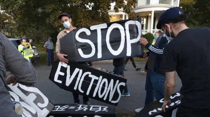 FILE - In this Oct. 14, 2020, file photo, housing activists erect a sign in Swampscott, Mass. A federal freeze on most evictions is set to expire soon. The moratorium, put in place by the Centers for Disease Control and Prevention in September, was the only tool keeping millions of tenants in their homes. (AP Photo/Michael Dwyer, File)