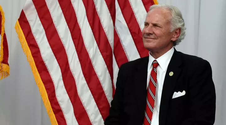 FILE - South Carolina Gov. Henry McMaster listens as Nephron Pharmaceuticals Corp. CEO Lou Kennedy speaks during the rollout of her new company, Nephron Nitrile, which Kennedy says will manufacture medical gloves as part of an effort to shore up the U.S. medical supply chain, Thursday, July 15, 2021, in West Columbia, S.C. 