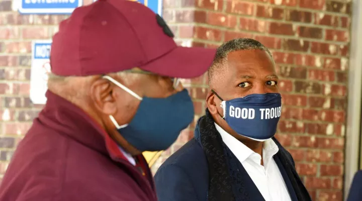 FILE - In this Nov. 3, 2020 file photo, Steve Benjamin, mayor of Columbia, S.C., right, looks on as U.S. House Majority Whip Jim Clyburn, left, speaks with a voter outside a polling place in Columbia, S.C.  During a city council meeting on Tuesday, Aug. 3, 2021,   Benjamin said that he was considering issuing a new state of emergency for the city, a declaration that he said would allow him to impose mask requirements.  (AP Photo/Meg Kinnard, File)