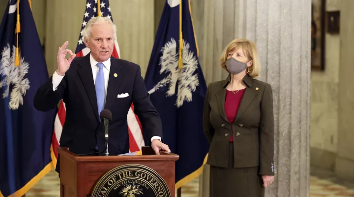 FILE - In this Thursday, Feb. 4, 2021, file photo, South Carolina Gov. Henry McMaster, left, and state Education Superintendent Molly Spearman, right, talk about a Senate proposal to get teachers COVID-19 vaccines immediately, in Columbia, S.C. A budget proviso that went into effect July 1 prohibits school districts in South Carolina from using appropriated funds “to require that its students and/or employees wear a face mask at any of its education facilities.” The measure was backed by Gov. McMaster.  (A…