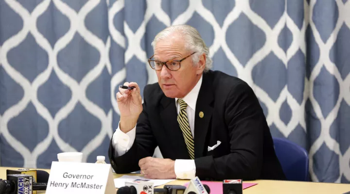 South Carolina Gov. Henry McMaster looks at data about the COVID-19 spread in the Kershaw County School District during a discussion with school officials at Camden Elementary School on Wednesday Sept. 15, 2021, in Camden, S.C. Nurses, principals and school board members were part of the roundtable discussion. (AP Photo/Jeffrey Collins).