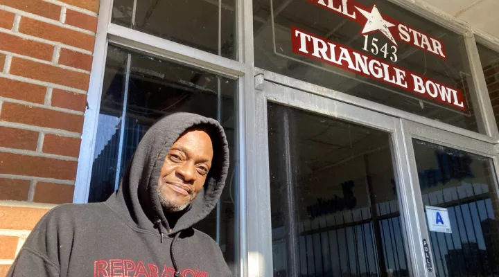 Orangeburg resident John Graves poses outside the All-Star Bowling Lanes in Orangeburg, S.C., on Sunday, Jan. 30, 2022. Graves and other visitors toured the empty bowling alley ahead of the 54th anniversary of the Orangeburg Massacre, when state troopers shot into a crowd of students protesting to integrate the business, killing three and wounding 28. (AP Photo/Michelle Liu)